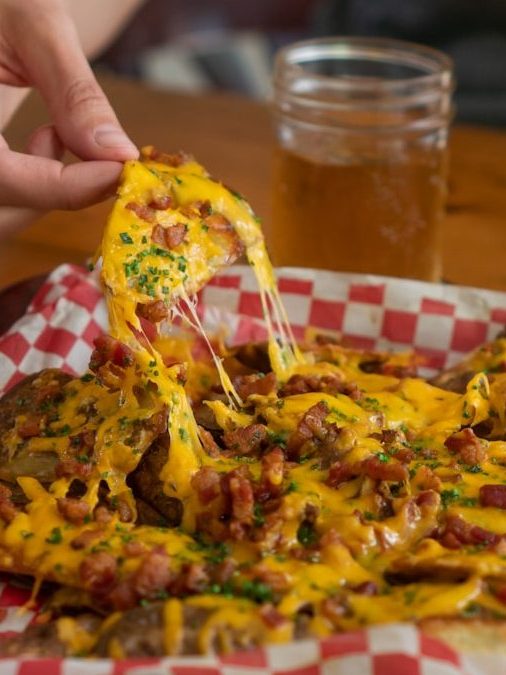 person holding cooked food on plate